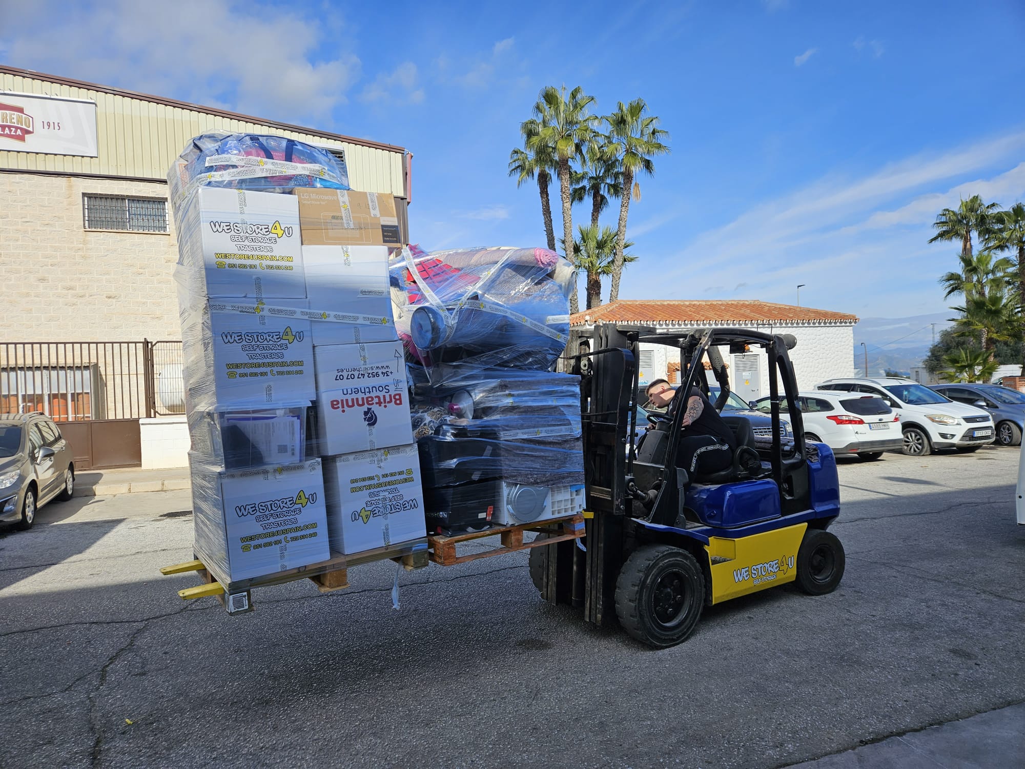 Forklift loading packed items for international removals